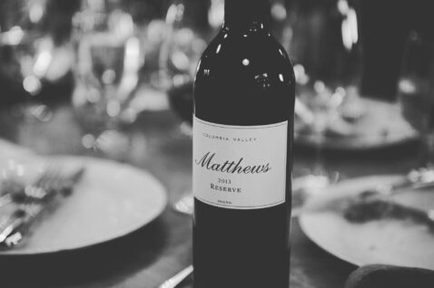 A black and white shot of a bottle of 2013 Reserve sitting on a dining table