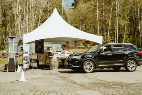 A car pulled up in front of curbside pick up tent