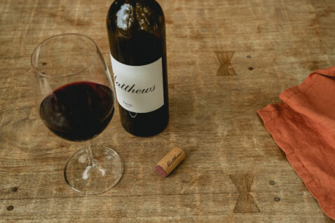 Looking down on a bottle and glass of 2018 Cuvee