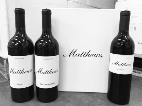 2013 vintage bottles of Merlot, Cab Sauv and Reserve lined up next to a Matthews box