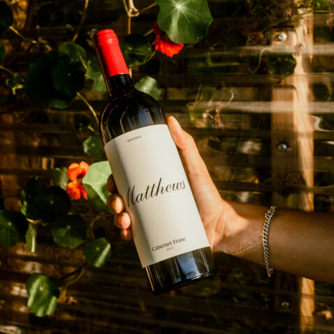 Close up of hand holding bottle of Reserve Cabernet Franc