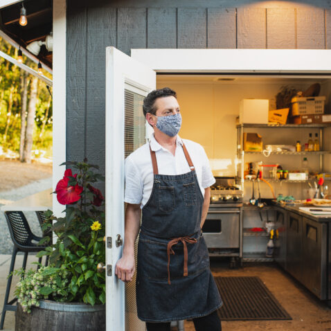 Chef Matt Lederman standing outside of the farm kitchen looking off into the distance