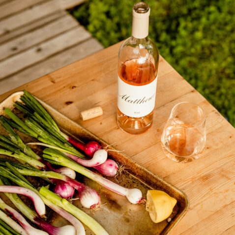 2018 Rose bottle, stemless glass and fresh radishes on stems