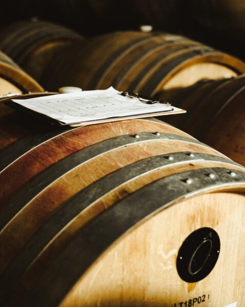 Paper on clipboard sitting on top of a barrel