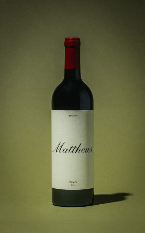 Studio shot of 2018 Reserve Cuvee bottle with muted green background