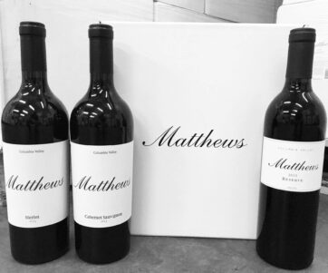 2013 vintage bottles of Merlot, Cab Sauv and Reserve lined up next to a Matthews box